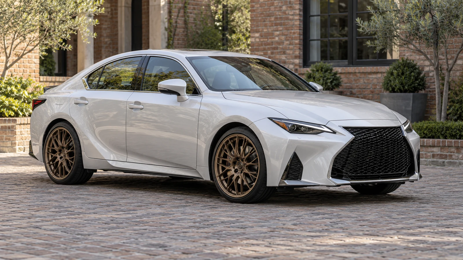 Silver-white sports sedan with bronze mesh wheels